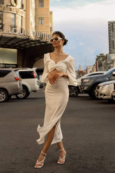 High-waisted silk midi skirt with side slits and sleek tailored silhouette for modern elegance